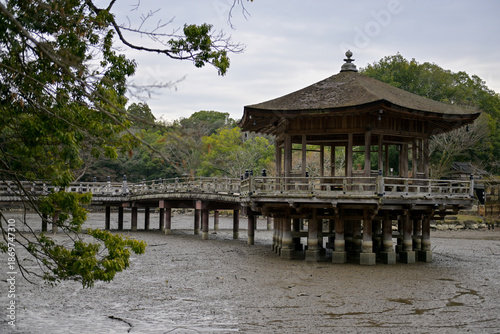 A wooden gazebo in the middle of a dried-up lake in Nara Park, Japan