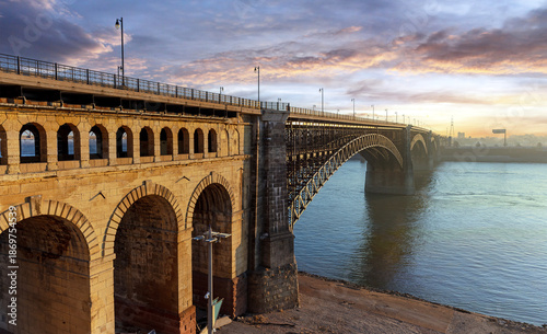 Scenic sunrise view of the Eads Bridge crossing the Mississippi River from St. Louis, MO to East St. Louis, IL