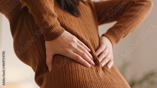 office syndrome in office worker concept, female touching her back suffering from muscle pain from sitting position during work.