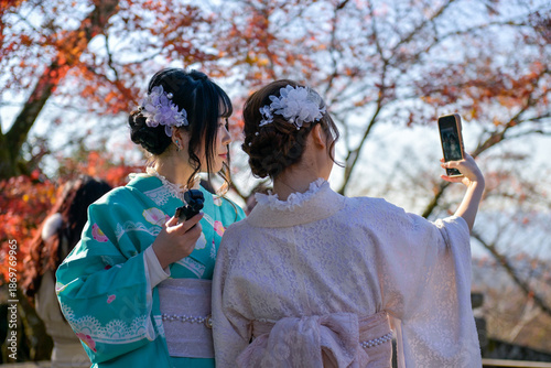 Two girls in Japanese national dress walk the streets of Kyoto, Japan