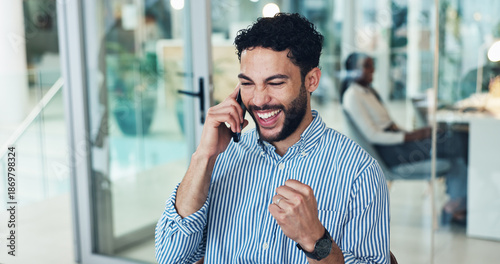 Happy, businessman and winning with phone call in office for promotion, bonus or good news. Excited, man or employee with smile, fist pump or mobile smartphone for business success or salary increase