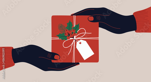 Two pairs of hands in red sweaters exchanging a gift box wrapped in red paper with a festive holly and berry decoration.