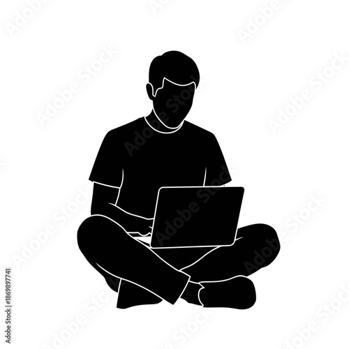 Silhouette of young boy sitting cross-legged on floor working on laptop computer, symbolizing remote freelance job, online education study, and digital nomad lifestyle.