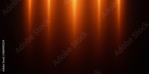 Warm golden light beams shining down on dark background with reflections