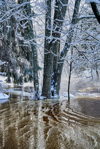 Flooding ice covered river in very cold winter day