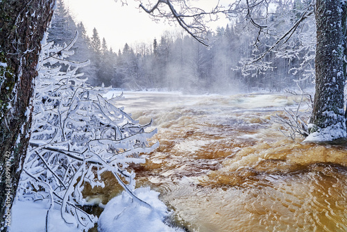 Flooding ice covered river in very cold winter day