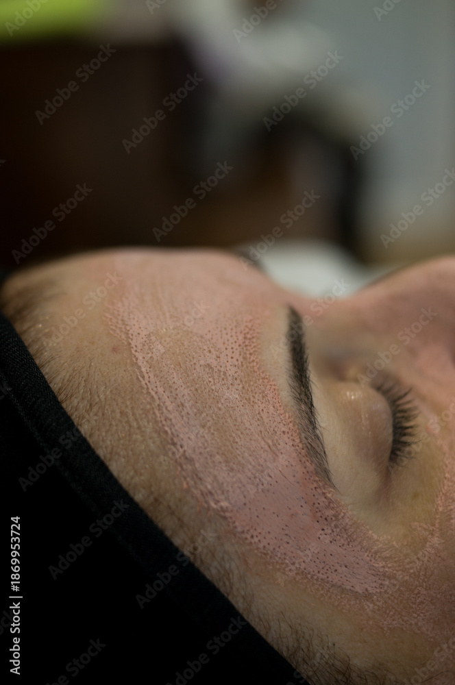 © Phoscar - High angle view of a woman relaxing during a professional spa treatment. Her face is covered with a pink purifying clay mask. Concept of dermatology and cosmetic therapy. © Phoscar - High angle view of a woman relaxing during a professional spa treatment. Her face is covered with a pink purifying clay mask. Concept of dermatology and cosmetic therapy.