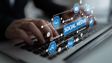 A close-up view of hands typing on a laptop keyboard, featuring social media icons and graphics that represent online communication and engagement in the digital age. Tessel
