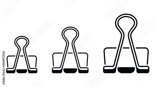 Three black and white paper clips of different sizes aligned horizontally orange