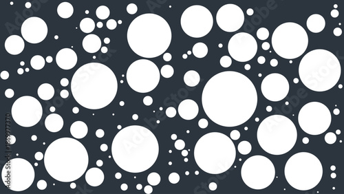 Floating bright bubbles create a dynamic visual pattern on a solid dark grey surface
