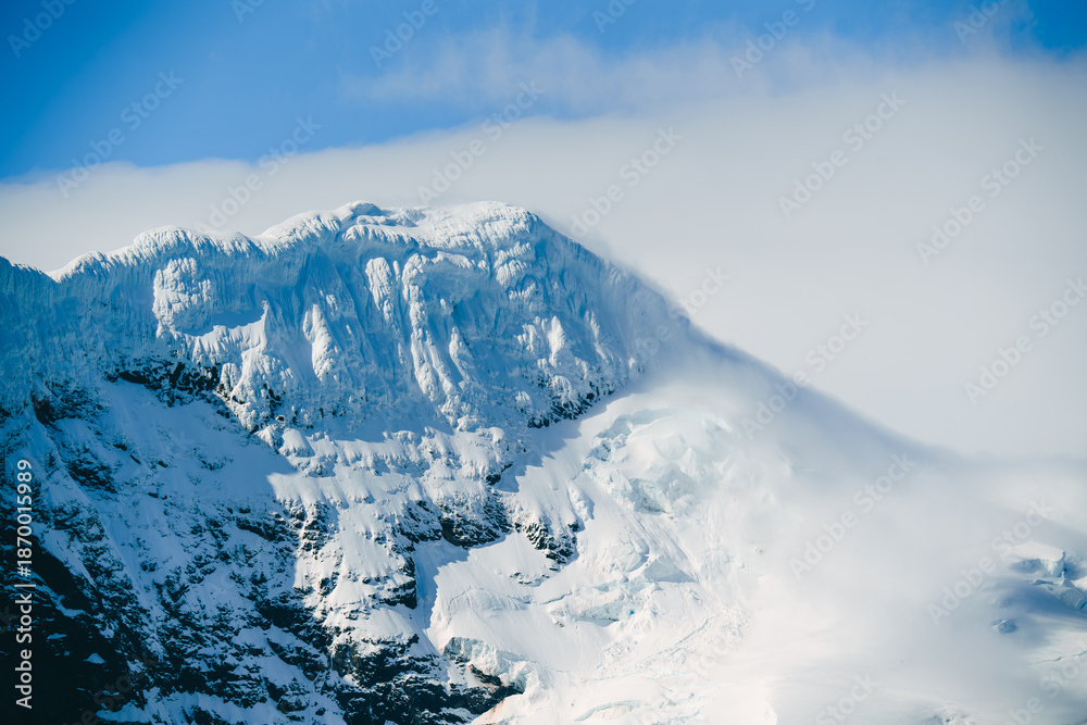 Fototapeta premium Antarctica Beautiful Mountain Peak Snow Covered Clouds Rolling in. Nature Adventure Travel Climate Change Remote Fine Art Photography Elephant Island