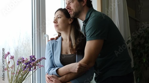 Mature couple hugging hugging each other kissing at home bedroom. Intimate Moment. Tender embrace shared between a loving middle age man and woman, husband and wife. Deep love. Low key, cinematic.