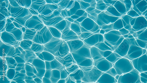 Abstract shot of clear blue water with dancing caustic sunlight patterns and soft ripples.
