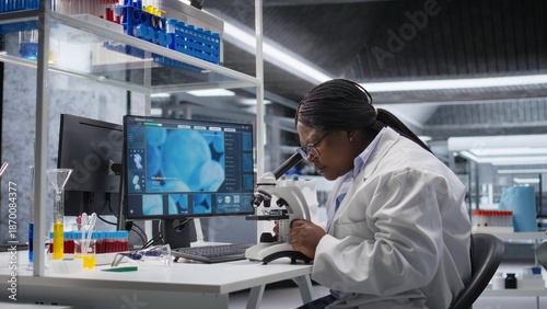 Εκτύπωση καμβά Black scientist examining samples under microscope in a modern laboratory