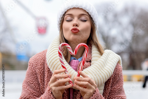 Young woman with candy cane...