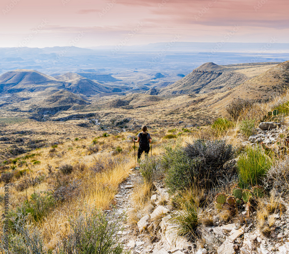 Fototapeta premium Female Hiker on The El Capitan Trail at Sunrise, Guadalupe Mountains National Park, Texas, USA