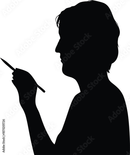 Senior individual silhouette in profile carefully holding a stylus or pen for writing or digital creation