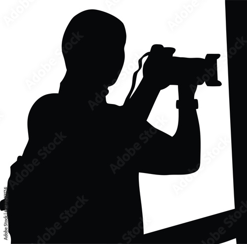 Silhouette of a photographer with camera capturing an important moment from an event or scene