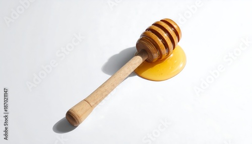 Honey dipper on a puddle of honey