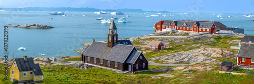 Typical architecture of Greenland Ilulissat with colored houses located near fjords and icebergs.