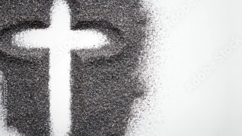 Animated sand art showing a cross shape being formed, symbolizing faith, religion, and spirituality on a light background.