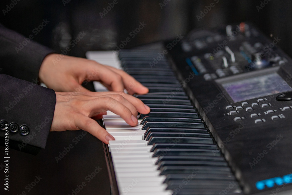 Fototapeta premium hands of a man playing the piano