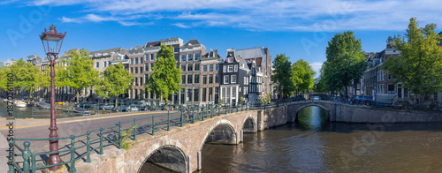 Obraz na plátně Holland, Amsterdam canals with boats, scenic bridges and historic city center, UNESCO World Heritage site