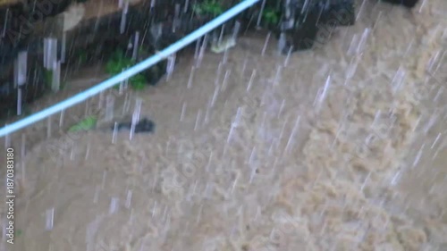 Tropical green river canal drainage during heavy rainfall in Thailand.