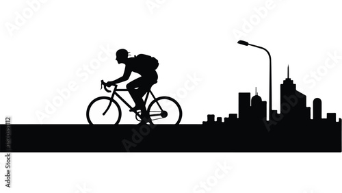 Silhouette of a cyclist with a backpack riding past a city skyline at dusk.