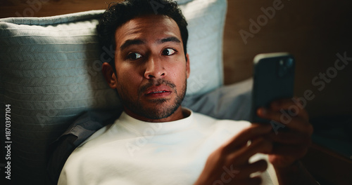 Photos Night, surprise and man with phone in bedroom, watch horror movie and loud noise for fear reaction