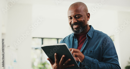 Photos Web designer, happy man or reading on tablet in home for remote work, plan or check homepage features