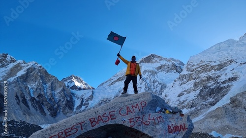 Photography Jubilant climber celebrates successful ascent, proudly waving national flag at h