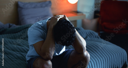 Insomnia, night and man in bedroom with stress for burnout, exhausted and fatigue for mental health. Tired, dark and person with upset, sad and anxiety for sleepless, bad dream and frustrated in home