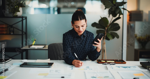 Phone, business woman or writing on paperwork in office, investment model plan or market trend notes. Review, forecasting project or financial analyst with mobile for data analysis, charts or graphs