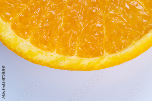 Clean orange slice positioned on pale background showing bright pulp and smooth rind, modern packaging aesthetic with negative space for text and branding, crisp and marketable