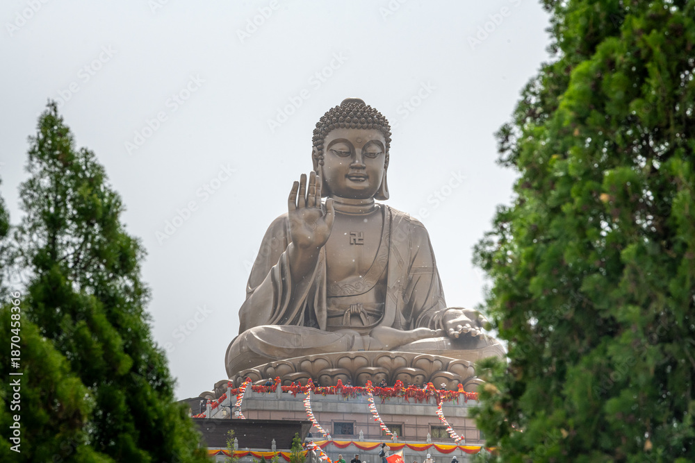 Fototapeta premium Close up on The Great Buddha Statue in the Nanshan scenic area of the Jiaodong Peninsula on a sunny summer day, Longkou, Shandong, China