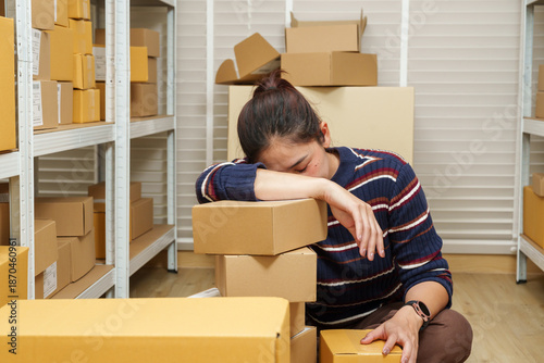 Photos asian woman small business owner resting head on returned parcel boxes showing f
