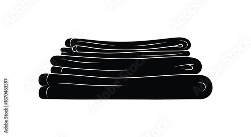 A neatly folded pile of dark towels presented in a striking black and white silhouette