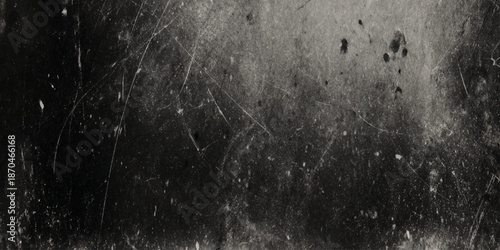 A deeply textured grayscale image showcasing a scratched and worn surface with subtle light and shadow variations