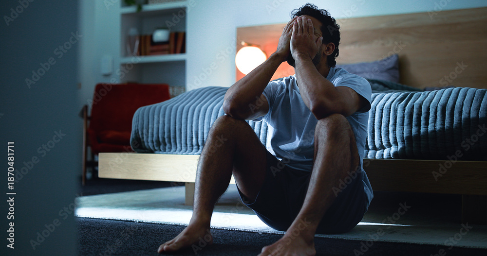 Obraz premium Insomnia, thinking and man in bedroom at night for burnout, exhausted and fatigue for mental health. Tired, dark and person with upset, sad and anxiety for sleepless, bad dream and frustrated in home