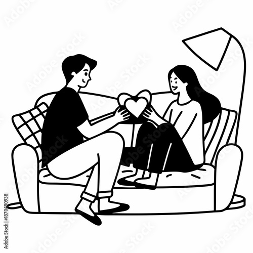 Happy Valentine's Day. Young couple in love exchanging gifts while sitting on the sofa in the living room at home. A man giving a heart-shaped gift box to his beloved woman