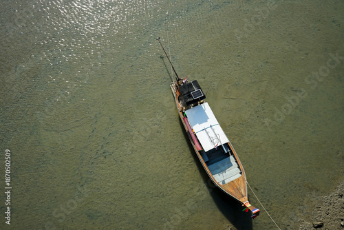Top view of wooden boat parking at the pier. Fisherman boat floating on the shore