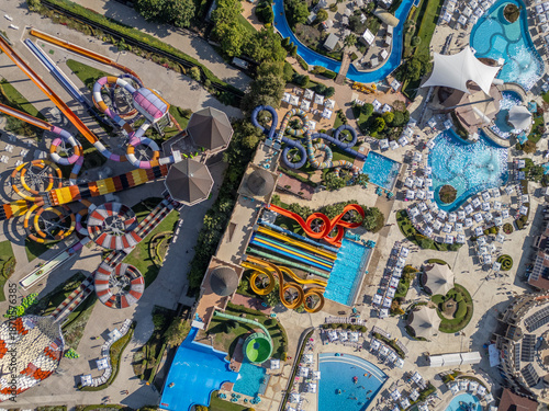 Top-down aerial view of a colorful water park in Nessebar, Bulgaria, with pools and slides. Vibrant summer resort scene showing leisure, recreation and tourism from a drone perspective