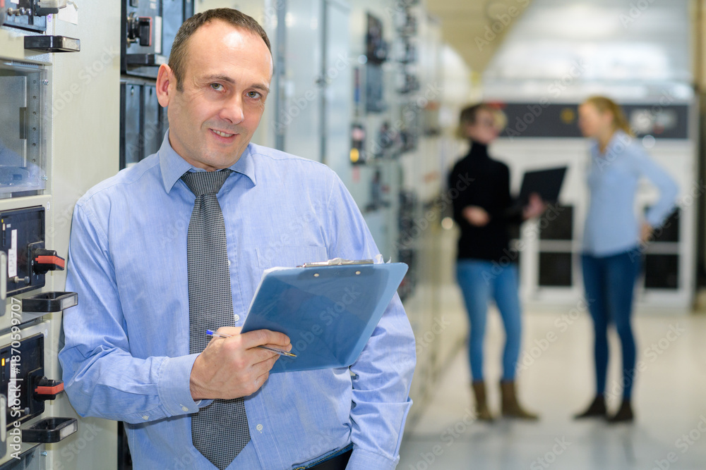 © auremar - a happy manager posing with clipboard © auremar - a happy manager posing with clipboard