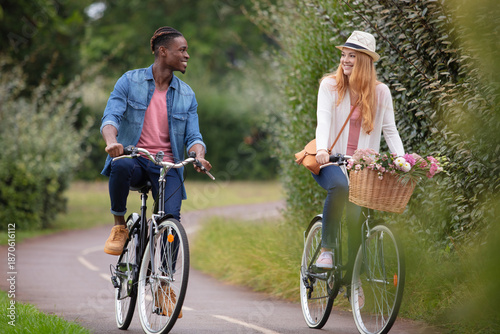 mixed-race couple cycling along cycle track