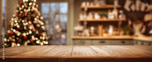 The wooden table in festive living room with blurred Christmas tree and bokeh lights