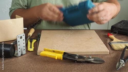 Wallpaper Mural A man checks work tools at his workplace. Torontodigital.ca