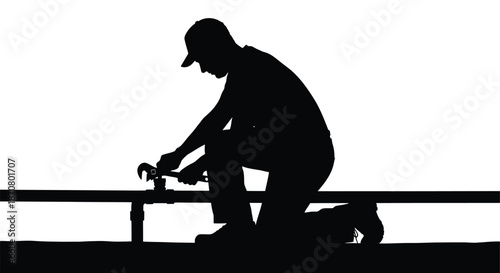 Silhouette of a man working with a wrench on a pipe