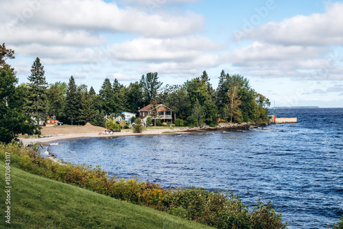 Canvas Print Lakeside view with beach, pier, cabin and pine trees, Le Domaine-du-Roi near Lac