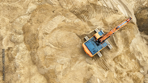 Excavator, soil movement, construction equipment, aerial photography from a drone, industrial excavation, large-scale construction of facilities. High quality photo
